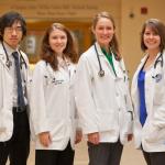 4 nursing students posing together for a photo - portrait style