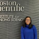 Photo of Saloni in front of a sign