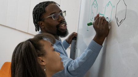 Student writing on a whiteboard