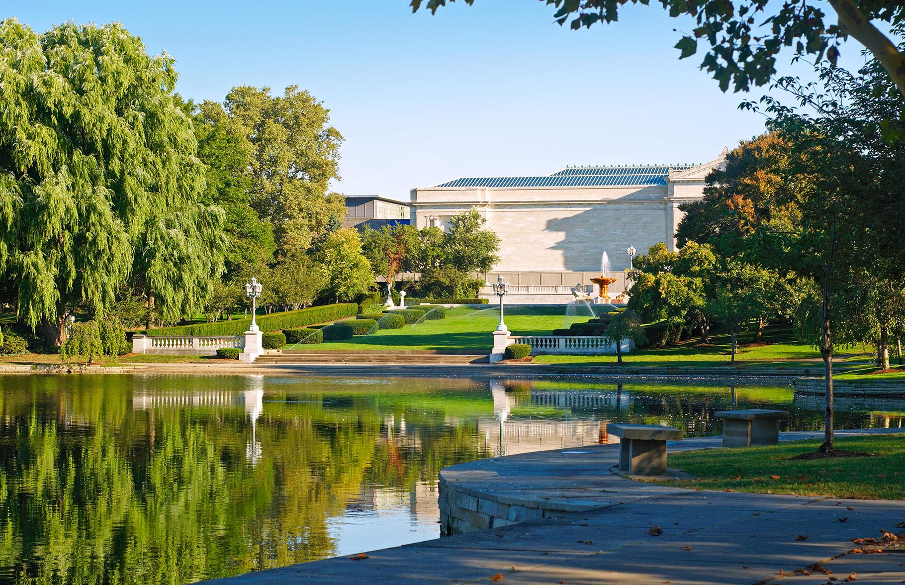 A view of the front of the Cleveland Museum of Art with the pond in front