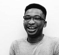 Akinola smiling at the camera