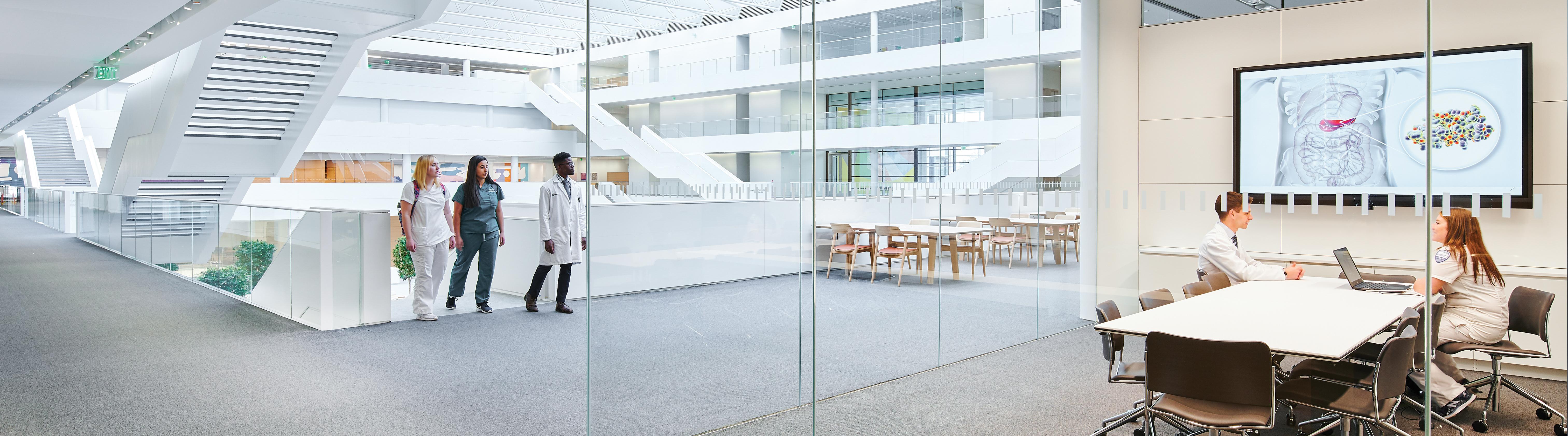 students walking in the halls of the Health Education Campus