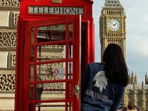 CRWU student leaning out of phone booth while in London