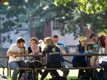 Students sitting at picnic tables