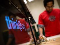 thinkbox logo on monitor with a student working in the background