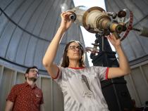 Student looks through telescope