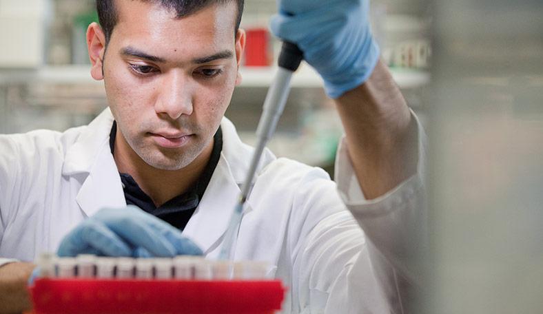 Student researcher measuring things with a pipette