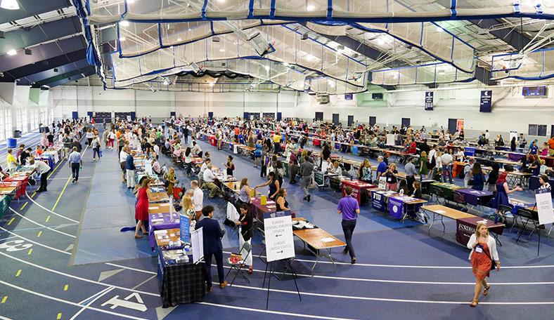 A college fair being held at a gym