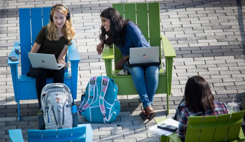 Students sitting outside in chairs