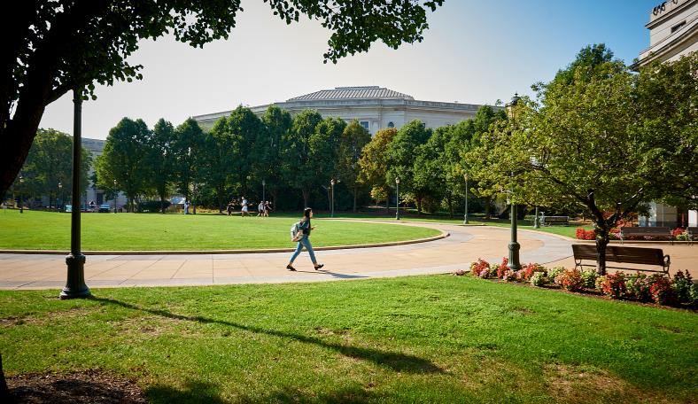 Student walking outside Kelvin Smith Library on Case Western Reserve University