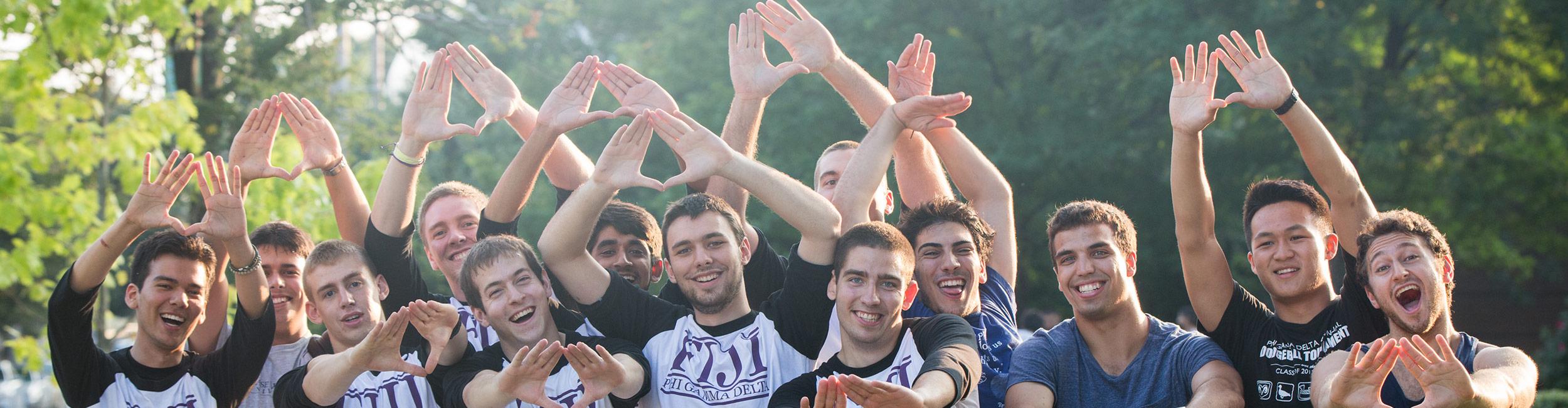 Group of guys with their hands in the air cheering