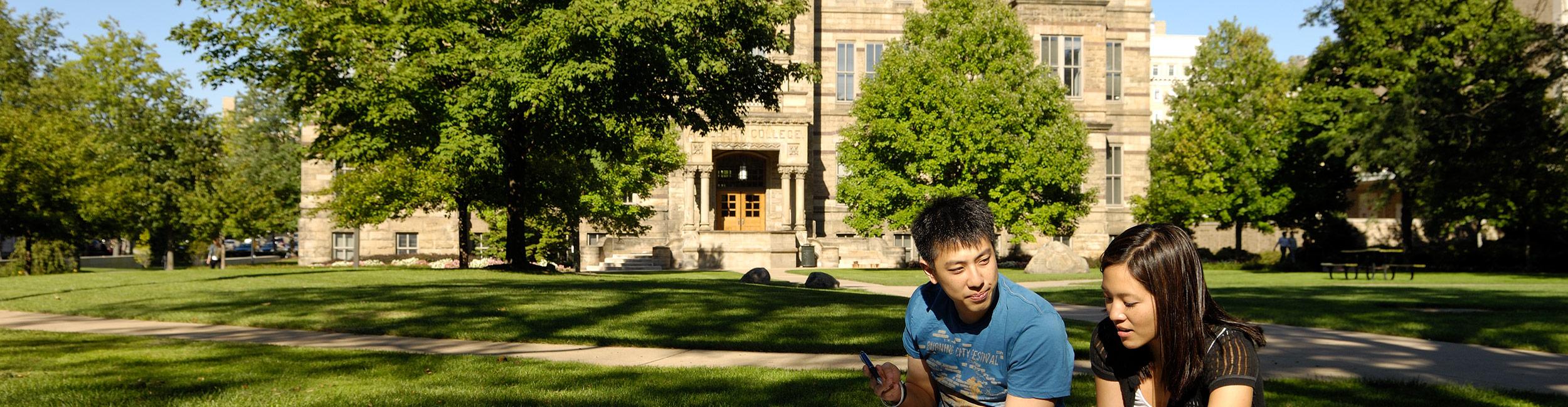 Students sitting on the grass in the quad