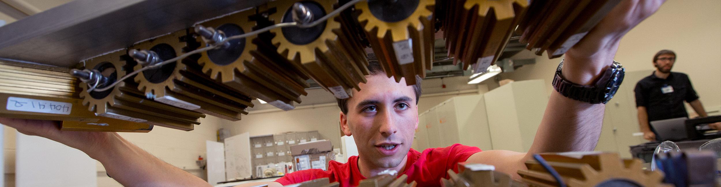 Student working on a machine in the thinkbox
