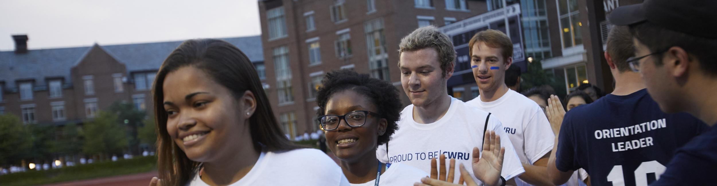Case Western Reserve University students high five during orientation