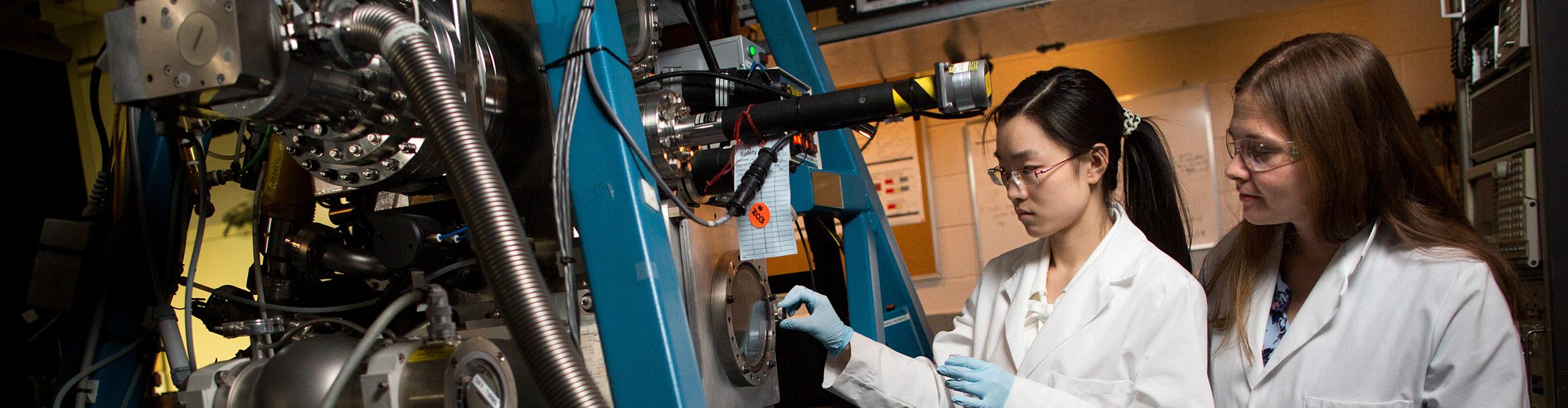 Two students working in a lab on a project