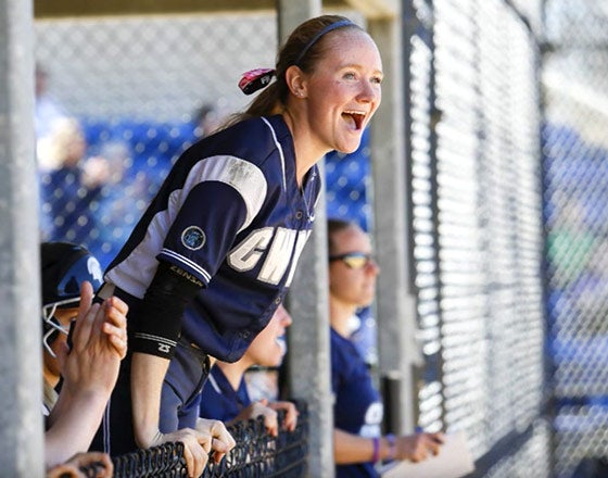 Softball team cheering on a player