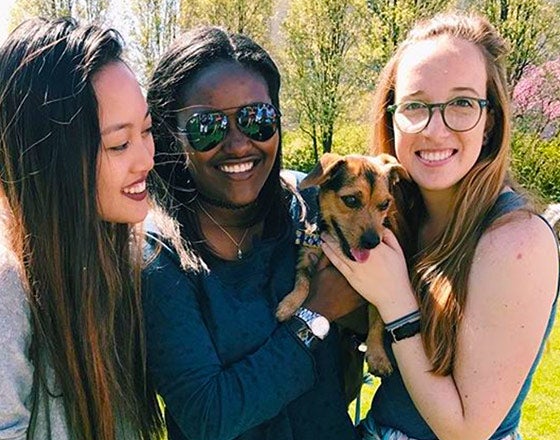 Sorority sisters holding a puppy