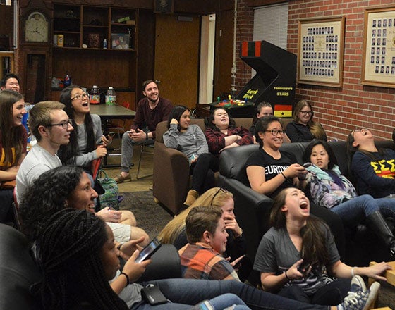 Students watching a movie in one of the larger common rooms