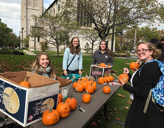 Random acts of kindness club giving away pumpkins