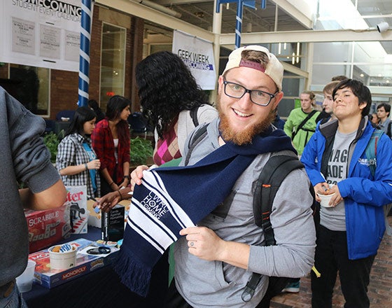 A student walking through the booths at the student org. fair