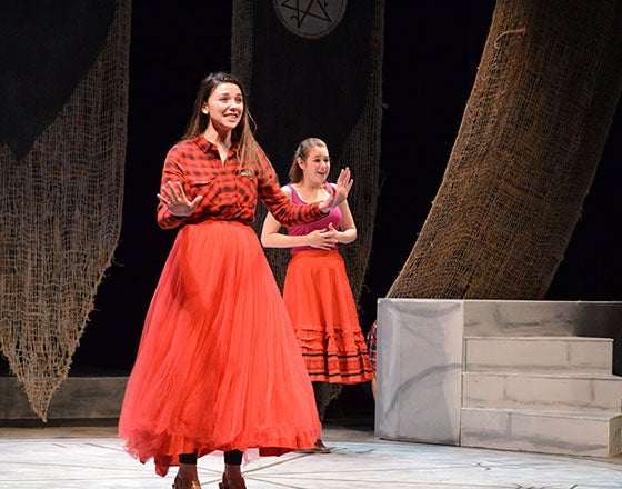 Sarah Young on stage giving a performance for The Illusion