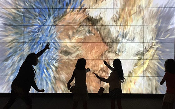 Children interacting with the art installation touch screen