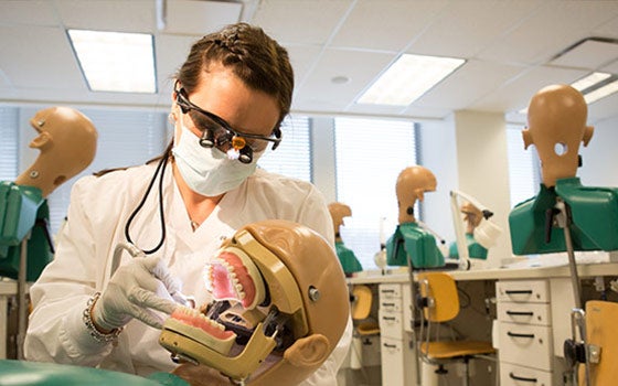 Dental student working in class
