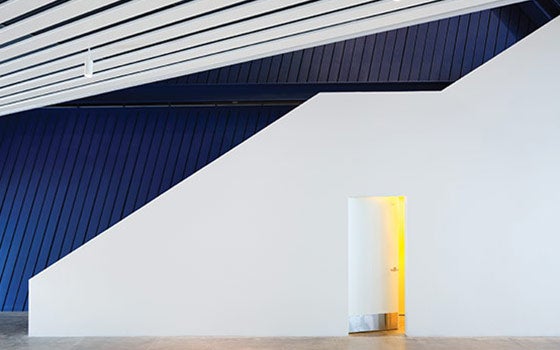 Interior view of the angles on the walls with a navy accent color on one wall