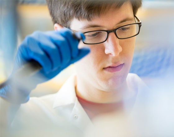 CWRU male student conducting medical research in lab