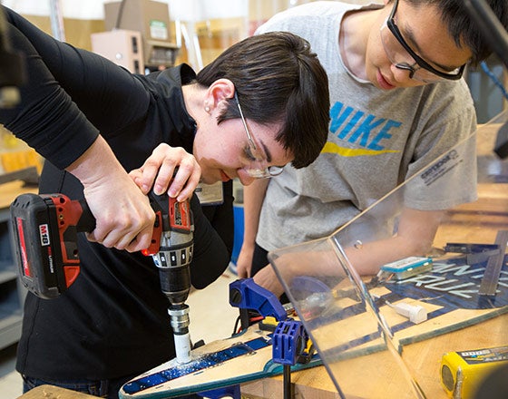 Students using power tools in the thinkbox