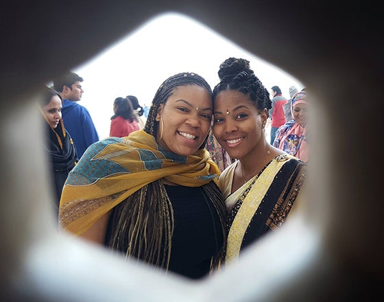View of two students in traditional attire through a hexagon