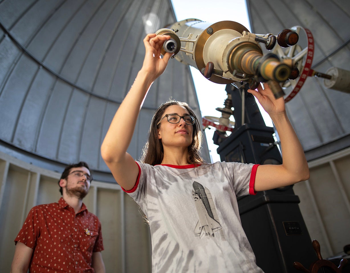 Student looks through telescope