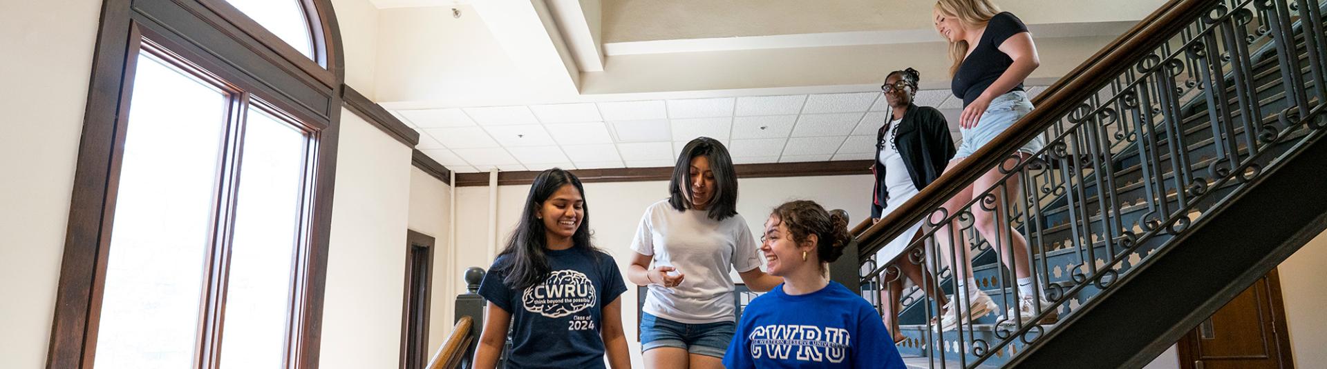 CWRU students walking down stairs while talking.