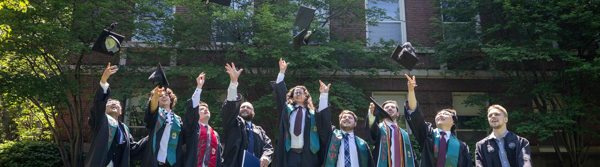 Several students posing at commencement