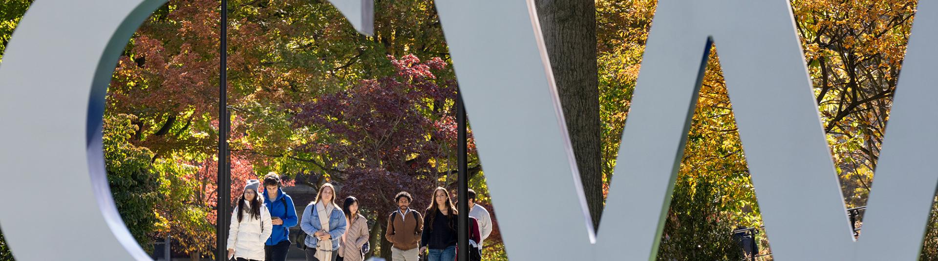 CWRU letter sign with students in background.