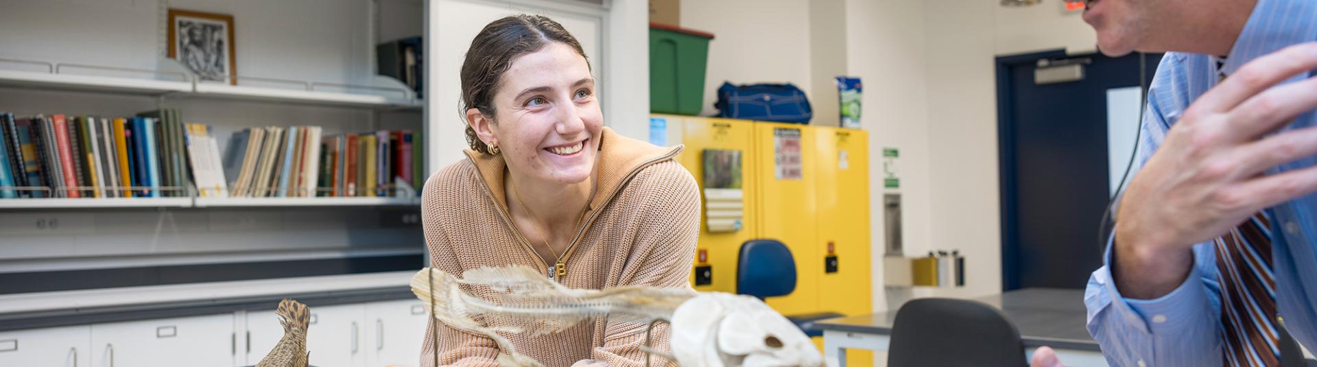 Student and professor in a biology lab.