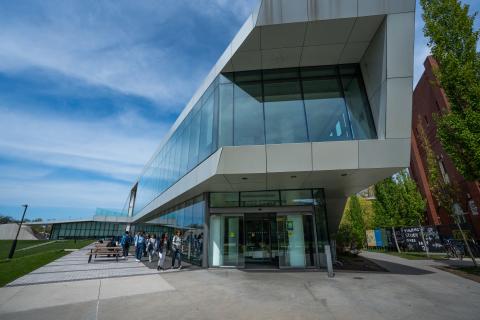 The Koch entrance of TINK head on with students walking to the entrance 