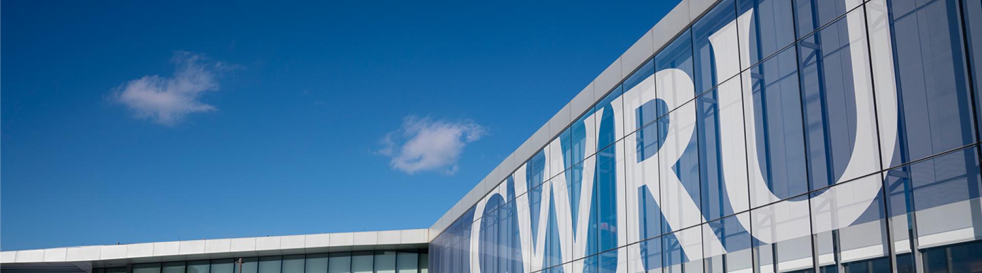 The CWRU banner as seen from the lawn outside of the Tinkham Veale University Center.