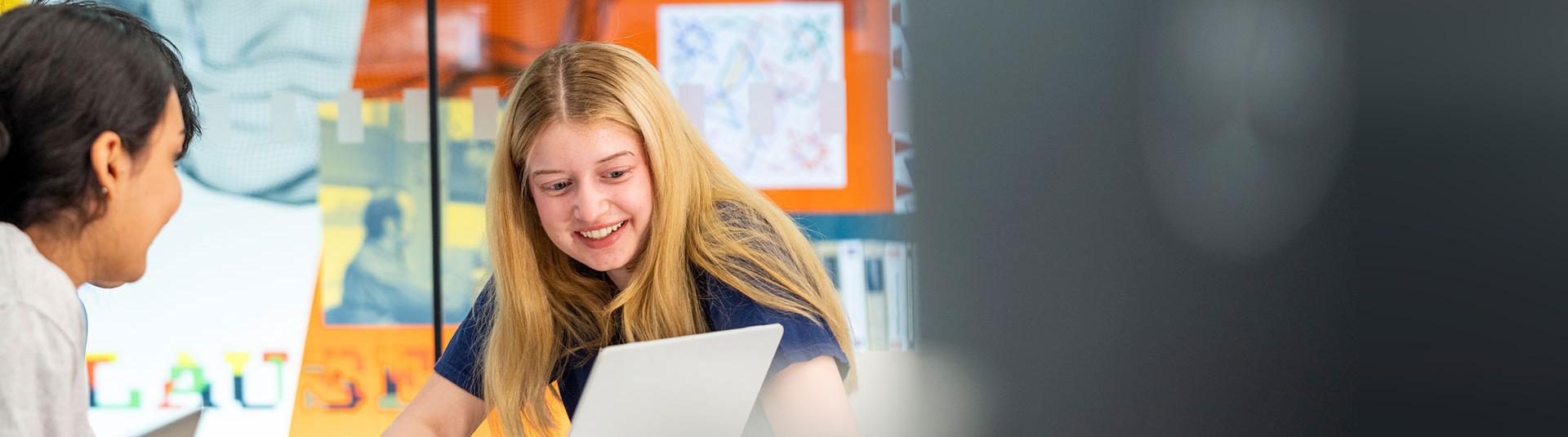 Two students looking at a computer