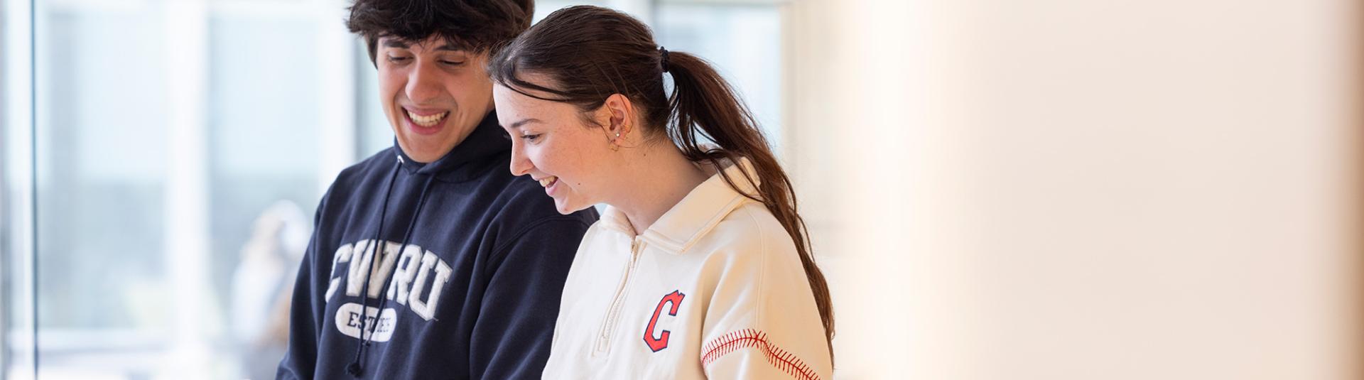 Two students looking at a laptop.
