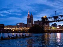 CWRU team rowing at night by downtown Cleveland
