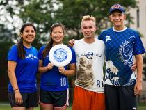 Ultimate Frisbee club posing with a frisbee after practice
