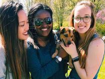 Sorority sisters holding a puppy