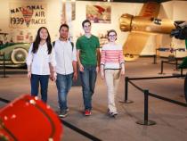 A group of four students walking through the Cleveland History Center Auto Aviation Museum