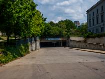 A photo of a parking garage entrance from the street