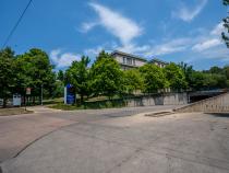 Photo of the entrance of a parking garage and a sign for the lot