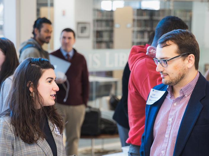 Individuals attending an Impact Talk talk together.