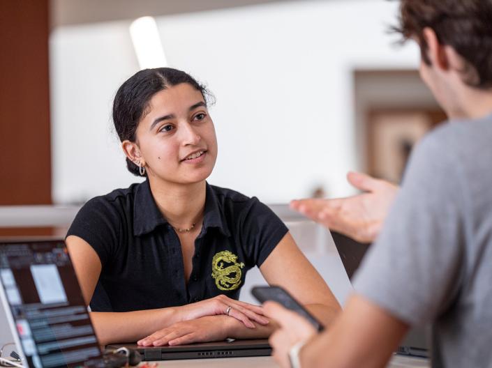 Female student in Weatherhead talking with another student.