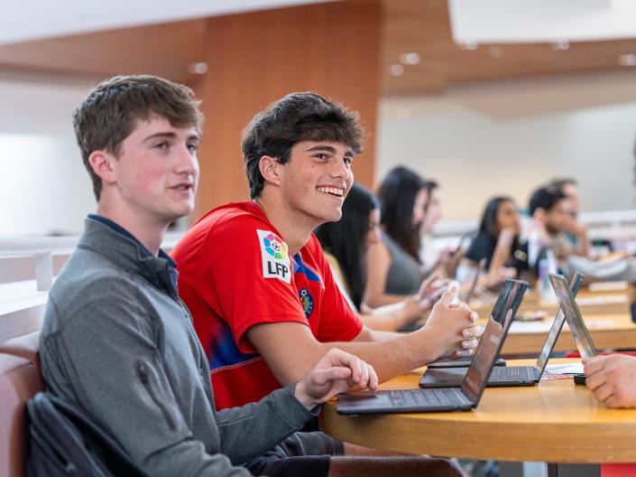 Students sitting in class listening.