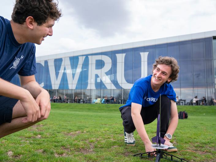 CWRU student setting up a small rocket to launch.